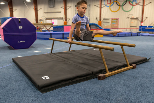 Boy doing gymnastics on a mat